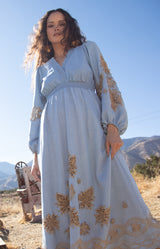 Paulina Embroidered Dress, color_light blue

Woman wearing a light blue dress with gold embroidery against a wooden background