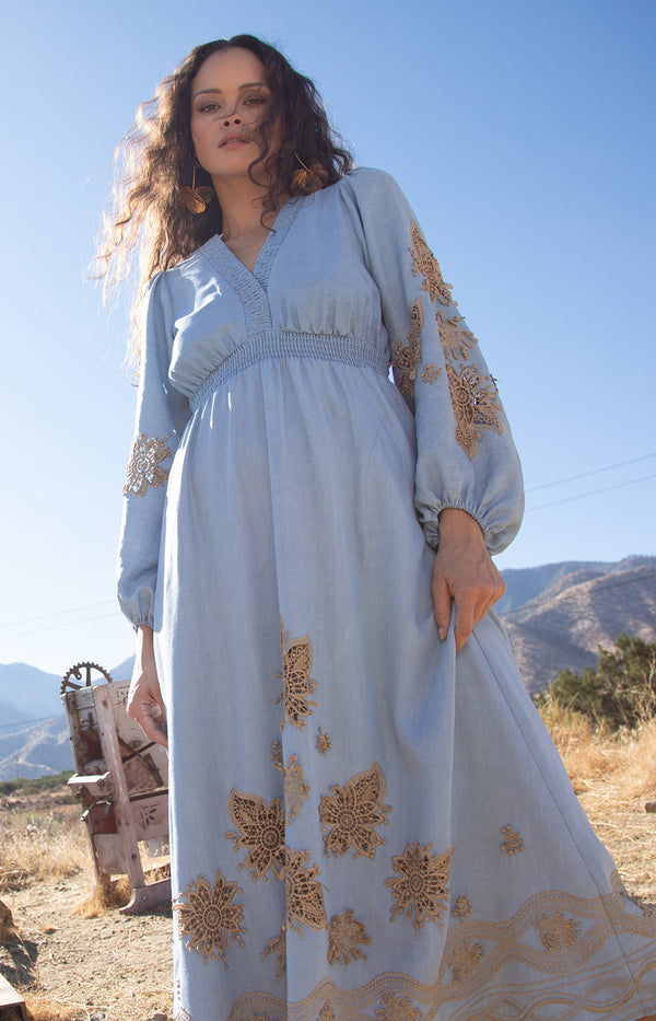 Paulina Embroidered Dress, color_light blue

Woman wearing a light blue dress with gold embroidery against a wooden background