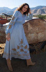 Paulina Embroidered Dress, color_light blue

Woman wearing a light blue dress with gold embroidery against a wooden background