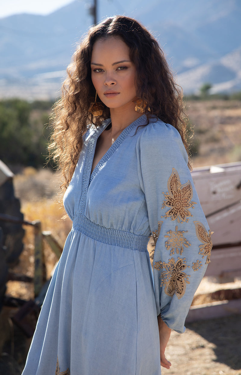 Paulina Embroidered Dress, color_light blue

Woman wearing a light blue dress with gold embroidery against a wooden background